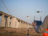 D-RTK 3 station on the survey pole and dual-lock tripod at a field survey site